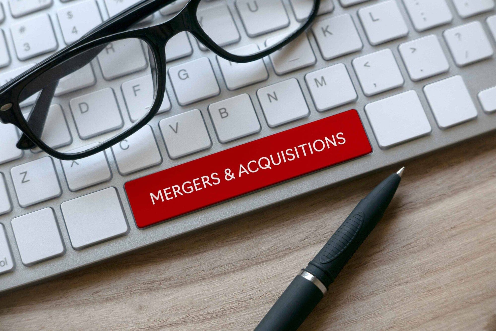 Forex Market Impact of Mergers represented in an image,