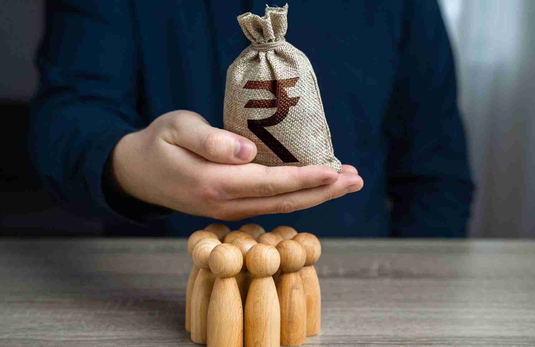 a-man-is-holding-a-indian-rupee-money-bag-over-a-g-2024-01-12-22-44-28-utc-min-scaled-1_11zon