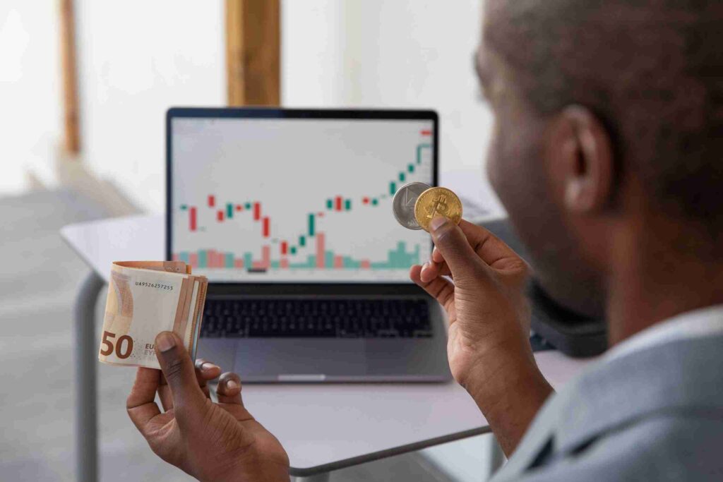 an-investor-holds-cryptocurrencies-and-cash-in-han-2023-11-27-05-28-45-utc-min-scaled-1_11zon